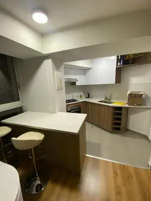 a kitchen with white cabinets and a counter top at Vista piso 24 in Lima