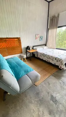 a bedroom with a large bed and a table at Cabaña2 con hermosa vista al valle in Oxapampa