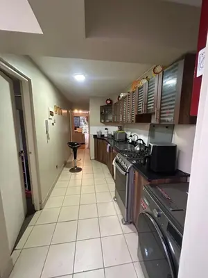 a kitchen with a sink and a stove top oven at Comodidad y Exclusividad in Lima