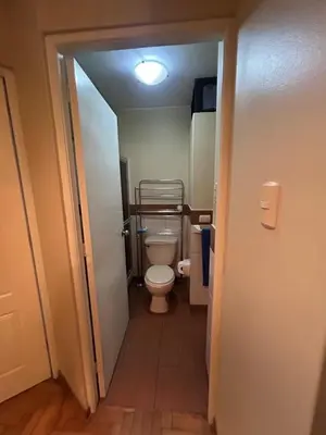 a small bathroom with a toilet in a hallway at Comodidad y Exclusividad in Lima