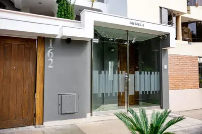 a facade of a building with a glass door at San Miguel Awanka Hotel in Lima