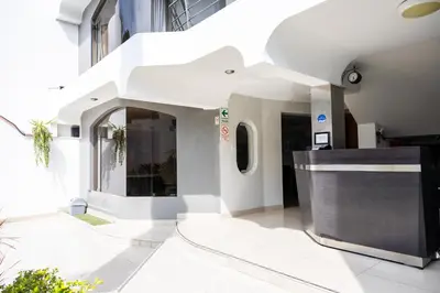 a lobby of a building with a reception counter at San Miguel Awanka Hotel in Lima