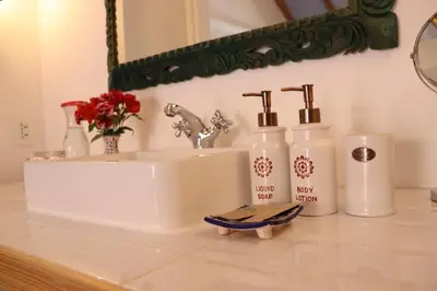 a bathroom with a sink and two bottles on a counter at Quinta San Blas by Ananay Hotels in Cusco