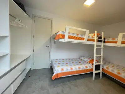 a bedroom with two bunk beds and a ladder at Casa de playa con vista al mar y piscina in Cerro Azul