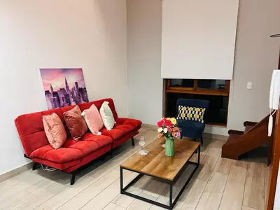 a living room with a red couch and a coffee table at MONTERRICO POLO APARTS #8 - Dpto de 2 camas Frente Embajada de USA con AC in Lima