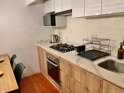 a kitchen with a stove top oven next to a sink at Entire House close to the sea Miraflores in Lima