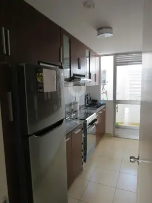 a kitchen with a stainless steel refrigerator and a stove at Temporal Apartment in Lima
