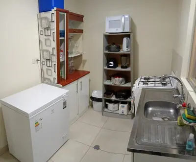 a kitchen with a white refrigerator and a sink at Sweet Rustic Home in Hacienda Santo Domingo