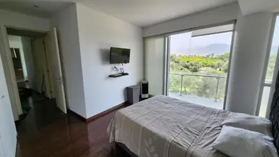 a bedroom with a bed and a large window at Apartamento de Lujo in Lima