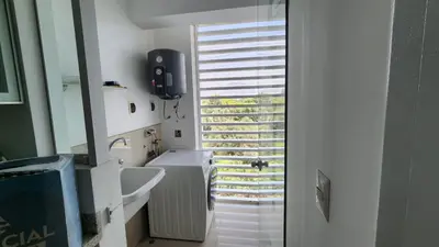 a bathroom with a white sink and a window at Apartamento de Lujo in Lima