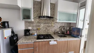 a kitchen with a stove and a counter top at Apartamento de Lujo in Lima