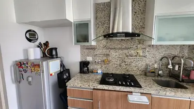 a kitchen with a refrigerator and a counter top at Apartamento de Lujo in Lima