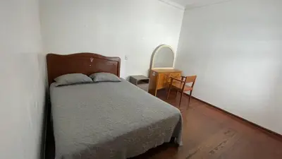 a bedroom with a bed and a table and a chair at Casa Extremadura in Lima