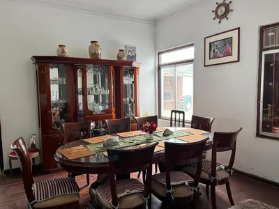 a dining room with a wooden table and chairs at Casa Extremadura in Lima