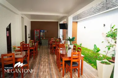 a restaurant with wooden tables and chairs at Grand Hotel Megantoni in Quillabamba