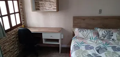 a bedroom with a desk next to a bed and a desk at Habitación A1 Trabajar Kitchenette y baño privado in Lima
