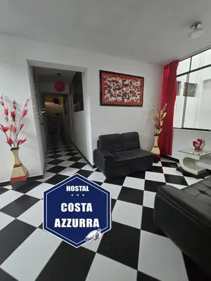 a living room with a black and white checkered floor at Hostal COSTA AZZURRA in Cerro Azul