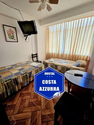 a hotel room with two beds and a sign that reads casita akiru at Hostal COSTA AZZURRA in Cerro Azul