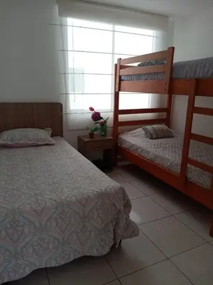 a bedroom with two bunk beds and a window at Departamento de playa in Asia