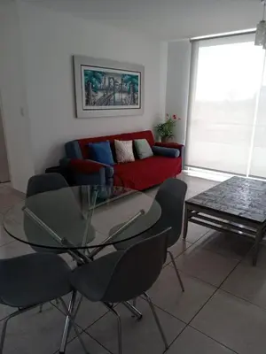 a living room with a couch and a glass table at Departamento de playa in Asia