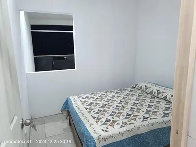 a small bedroom with a bed and a window at Mirador sur in San Bartolo