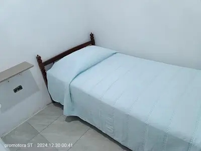 a bed in a room with a white bedspread at Mirador sur in San Bartolo