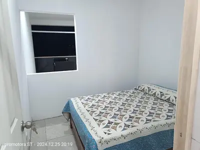 a small bedroom with a bed and a window at departamento frente al mar in San Bartolo