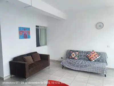 a living room with a couch and a chair at departamento frente al mar in San Bartolo