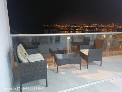 a balcony with chairs and a table with a view at departamento frente al mar in San Bartolo
