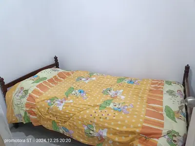 a bed with a blanket on top of it at Mirador del sur in San Bartolo