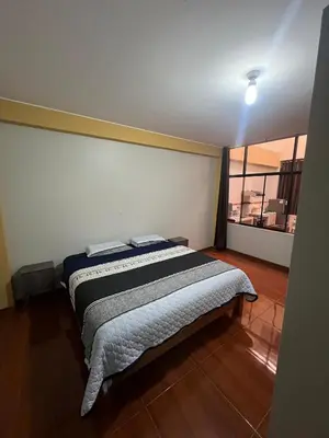 a bedroom with a bed in a room with a window at 2da Habitacion a 1 cuadra de la Plaza in Oxapampa