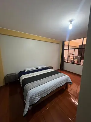 a bedroom with a bed in a room with a window at 2da Habitacion a 1 cuadra de la Plaza in Oxapampa