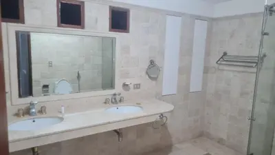 a bathroom with two sinks and a mirror and a shower at Casa de Playa Familiar in Puerto Viejo