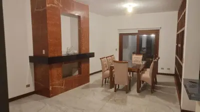 a dining room with a table and a fireplace at Casa de Playa Familiar in Puerto Viejo