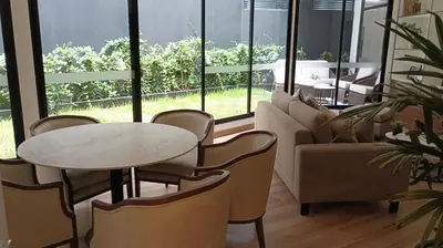 a living room with a table and chairs at Calm and beautiful apartment in San Isidro in Lima