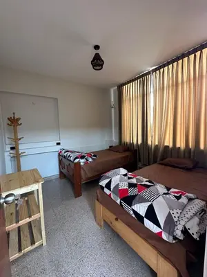 a bedroom with two beds and a window at San Bartolo house rental in San Bartolo