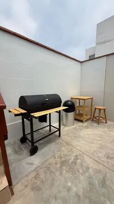 a room with a table and a grill on a table at San Bartolo house rental in San Bartolo