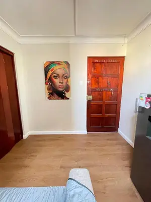 a room with a painting of a woman on the wall at Mini Apartment ARES in Lima