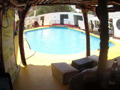 a large swimming pool in front of a building at Hospedaje snack bar titanic in Ica