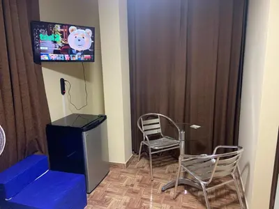 a room with a tv and a chair and a desk at Family Home Furnished Centro Chincha Alta in Chincha Alta