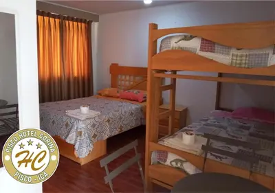 a bedroom with two bunk beds and a bed at Pisco Hospedaje Corina in Pisco