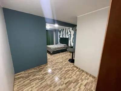 a hallway leading to a bedroom with a bed in a room at Agora Hs in Chincha