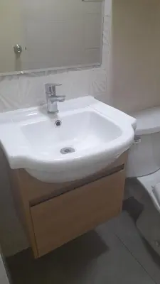a bathroom with a white sink and a toilet at DEPARTAMENTO Central in Lima