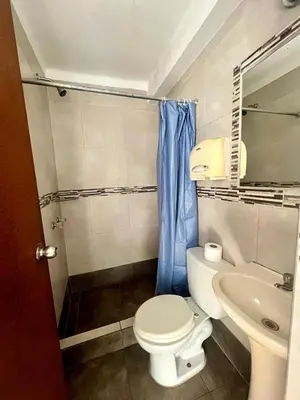 a bathroom with a toilet and a sink at Hostel rivendell lima in Lima