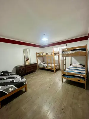 a room with three bunk beds in a room at Hostel rivendell lima in Lima