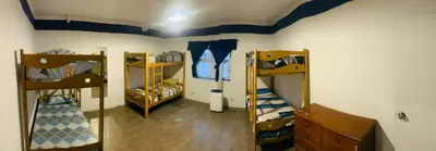 a room with three bunk beds and a blue ceiling at Hostel rivendell lima in Lima