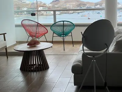 a living room with two chairs and a couch at Ocean View Premiere Depa Naplo in Naplo