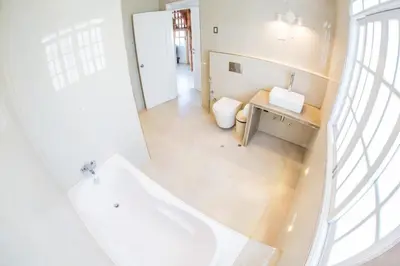 a bathroom with a tub and a toilet and a sink at Edelweiss Haus in Chontabamba