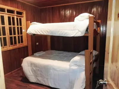 a couple of bunk beds in a room at Edelweiss Haus in Chontabamba