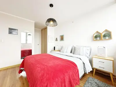 a bedroom with a bed with a red blanket at Moderno Dpto , Equipado, Céntrico, Vista Increible in Lima